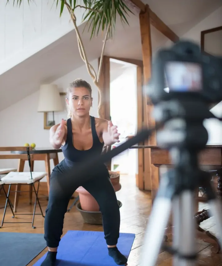 A fitness creator filming a workout