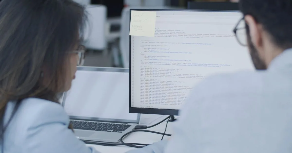 Two builders reviewing code together